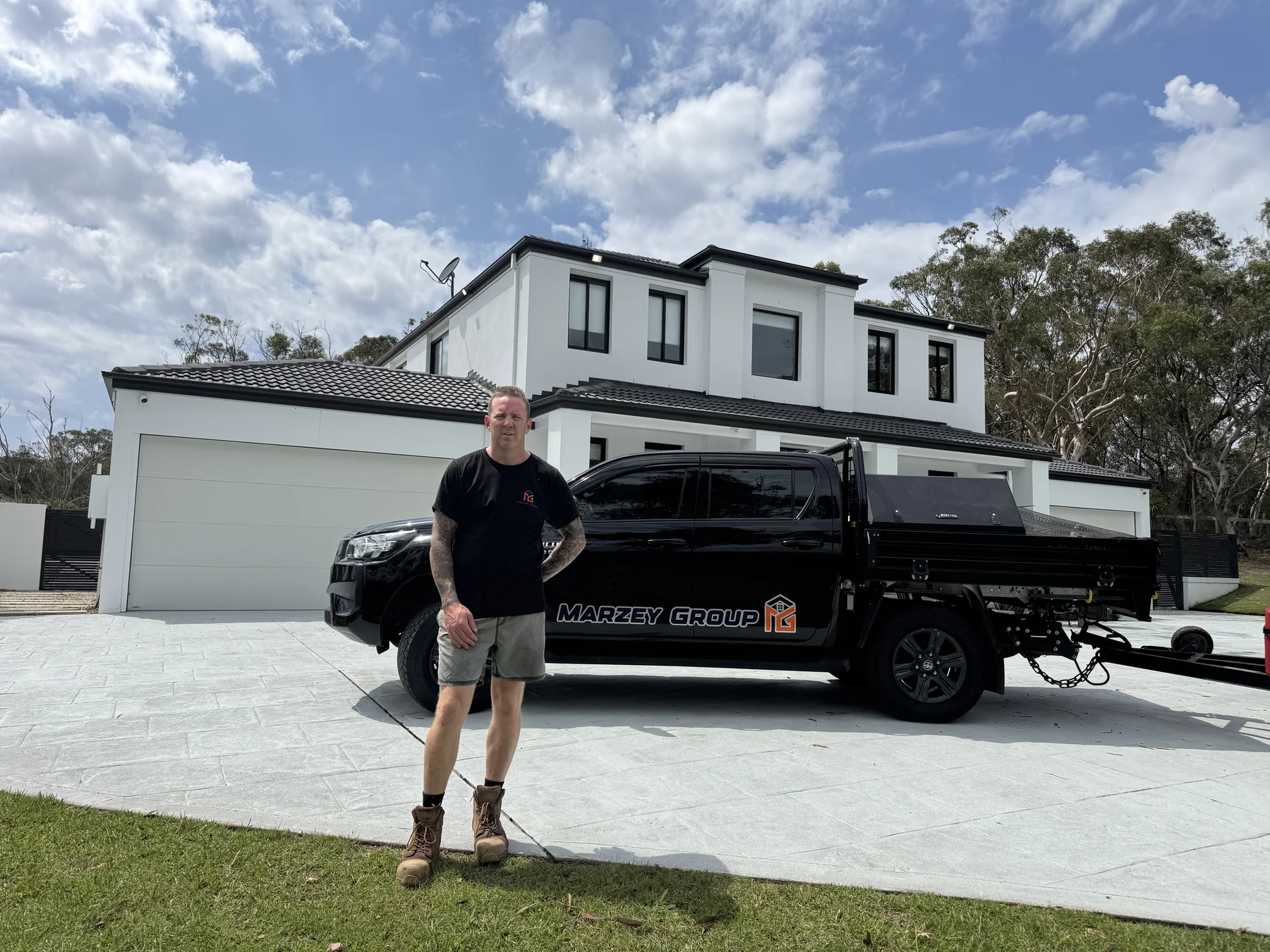 A Marzey Group team member standing in front of a branded work vehicle